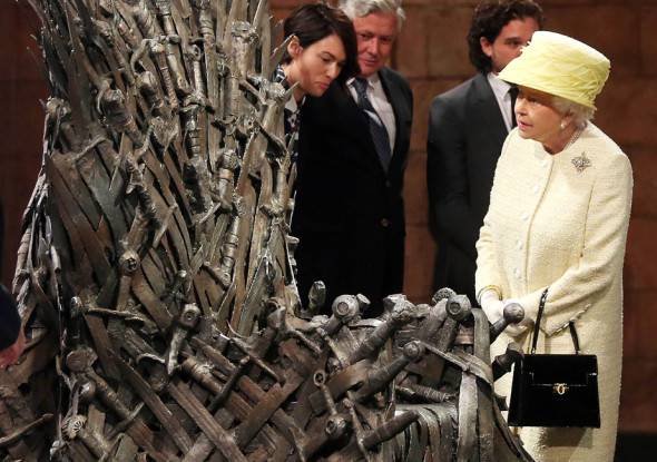 BELFAST, NORTHERN IRELAND - JUNE 24:  Queen Elizabeth II meets cast members of the HBO TV series 'Game of Thrones' Lena Headey and Conleth Hill as she views some of the props including the Iron Throne on set in Belfast's Titanic Quarter on June 24, 2014 in Belfast, Northern Ireland. The Royal party are visiting Northern Ireland for three days.  (Photo by Jonathan Porter - Pool/Getty Images)